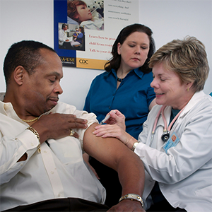 a doctor administers a shot to a man